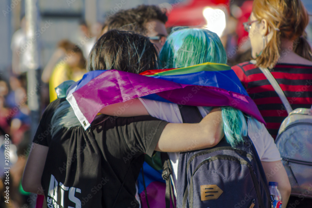 Girls with rainbow flag at an LGBT gay pride parade