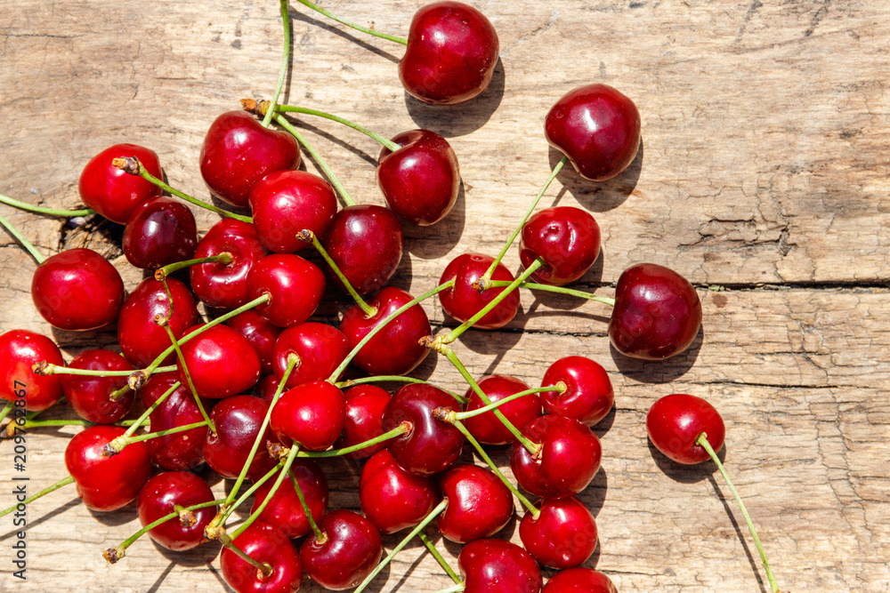 Fresh ripe cherries on rustic wooden table. Top view Fresh ripe cherries on rustic wooden table. Top view