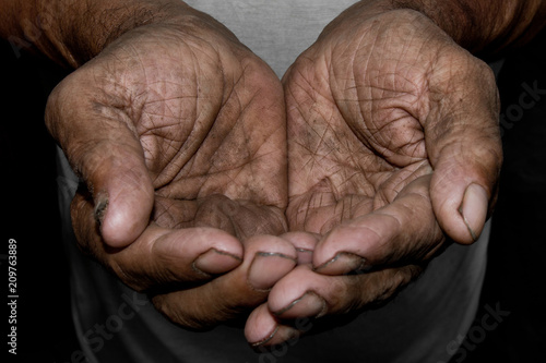 The poor old man's hands beg you for help. The concept of hunger or poverty. Selective focus.