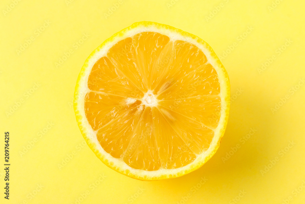Top view of a one orange fruit slice on bright background in pastel color. Top view of a one orange fruit slice on bright background in pastel color.