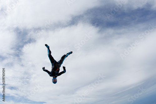 Freefly skydiving. Girl is falling is a headdown position.