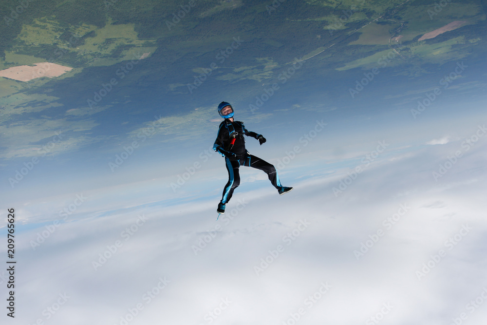 Freefly skydiving. Girl is falling is a headdown position.