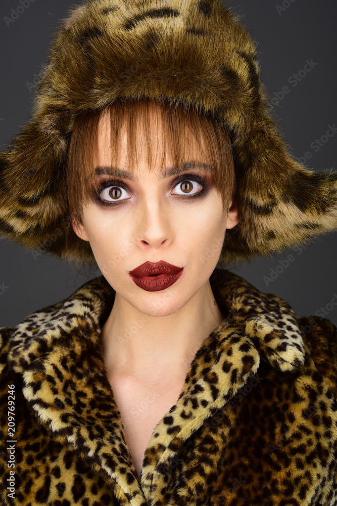 pretty woman in leopard fur coat and hat. pretty woman in leopard fur coat and hat.