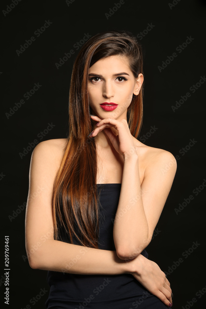 Attractive young woman with elegant makeup and long eyelashes on black background. Eyelash extensions Attractive young woman with elegant makeup and long eyelashes on black background. Eyelash extensions