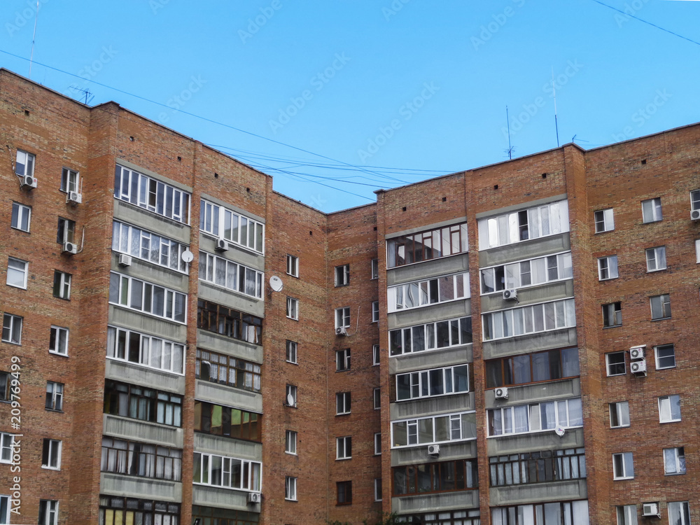 Modern apartment building. Multistory. Residential building. Apartment block. Blue sky