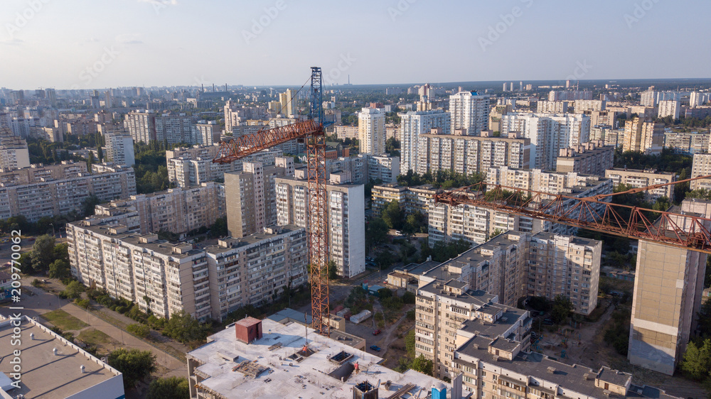 Aerial view on the building with construction cranes