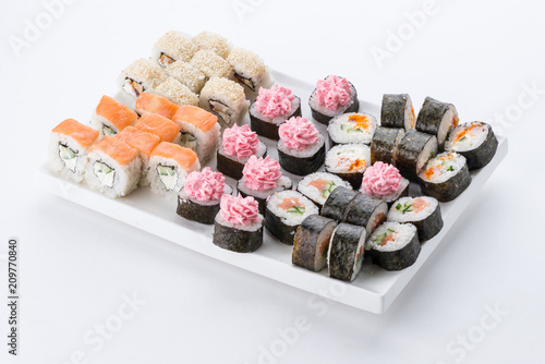 Sushi set and composition at white background. Japanese food restaurant, sushi maki gunkan roll plate or platter set. photo