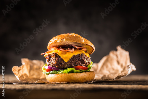 Obraz na plátne Close-up home made beef burger on wooden table