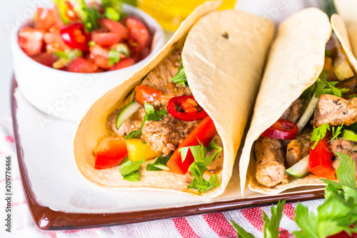 Mexican pork tacos with vegetables and salsa.