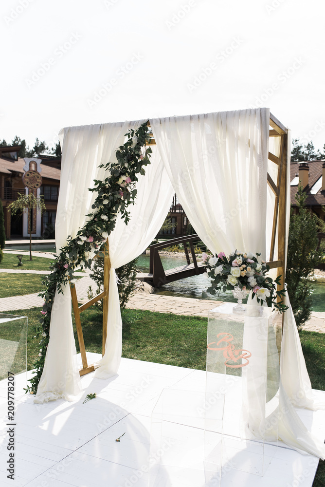 Beautiful wedding ceremony outdoors. Square wedding arch