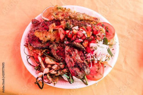 Meat with vegetable at the weekend food court on the main square of Juayua village, El Salvador photo