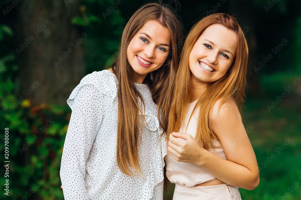 Obraz premium happy girls with a gentle make-up look into the camera lens and smile