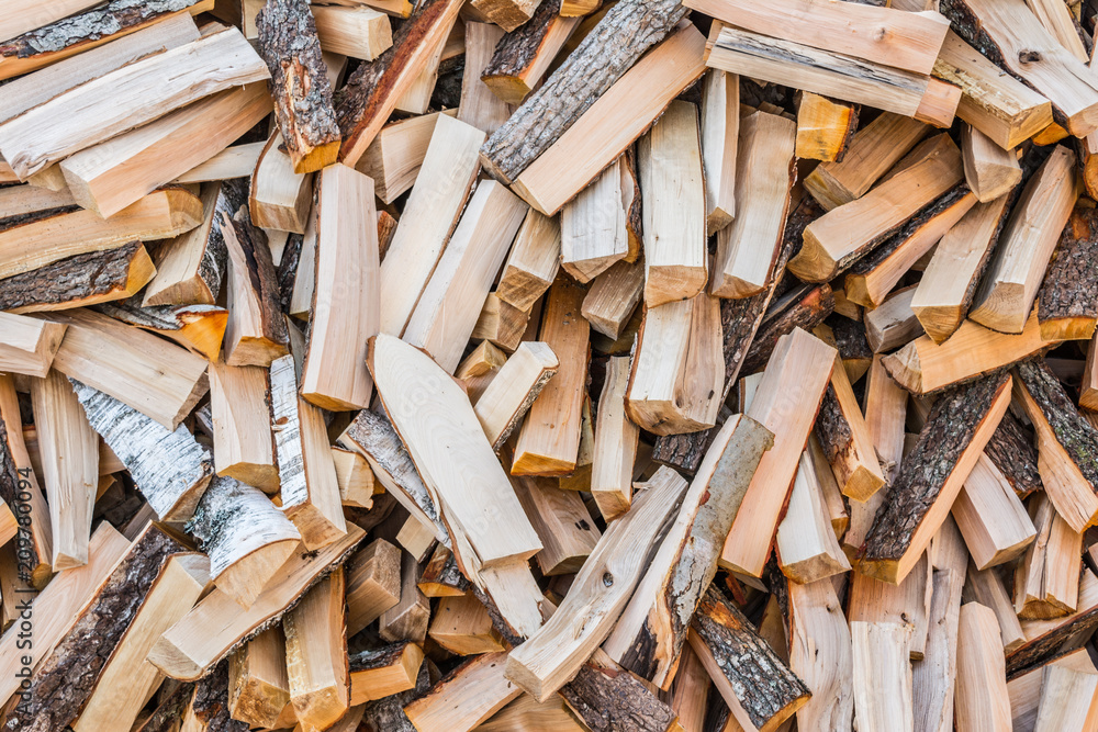 chaotically arranged in a pile of fresh chopped firewood, abstract background chaotically arranged in a pile of fresh chopped firewood, abstract background