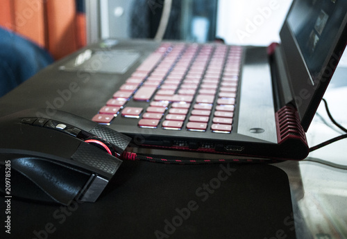 A red-black gaming laptop with a luminous keyboard