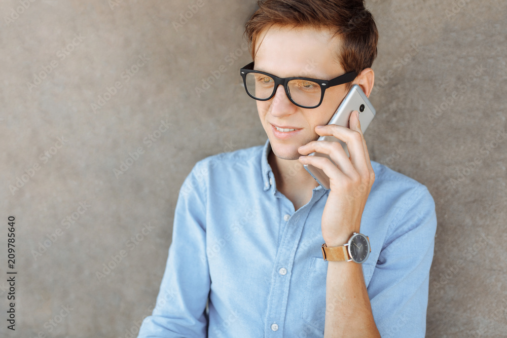 Beautiful stylish business guy with glasses, posing on the beach, hipster talking on the phone, work on vacation, for advertising, text insertion Beautiful stylish business guy with glasses, posing on the beach, hipster talking on the phone, work on vacation, for advertising, text insertion