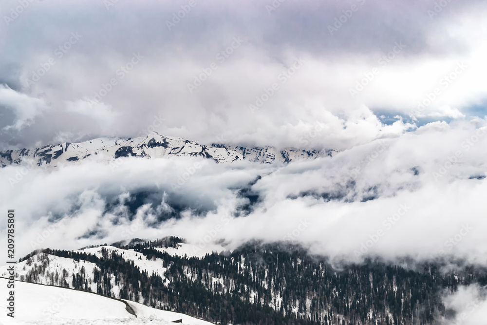Sochi, Russia, the tops of the mountains covered with forest and snow are dense.  dark clouds