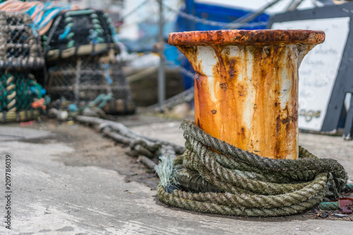 Bollard with a chain and a rope