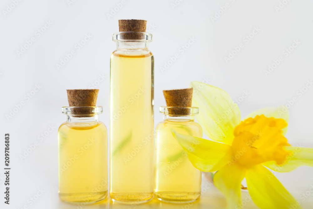 Essence of flowers on white in beautiful glass jar Essence of flowers on white in beautiful glass jar