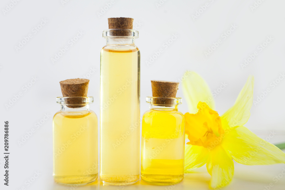 Essence of flowers on white in beautiful glass jar Essence of flowers on white in beautiful glass jar