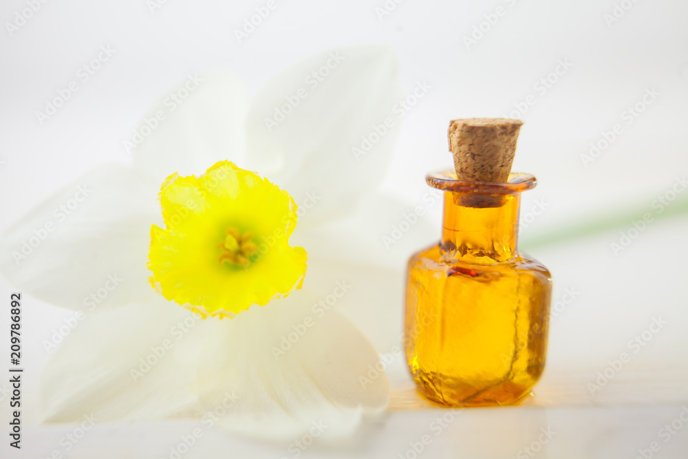Essence of flowers on white in beautiful glass jar Essence of flowers on white in beautiful glass jar