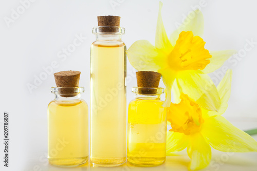 Essence of flowers  on white in beautiful glass jar