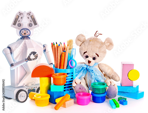 Robot toy and stuffed animals teddy bear and color pencils and cans of paint. White plastic device for children on isolated.