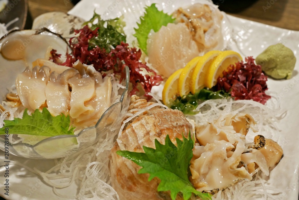 Assortment of fresh, raw seashell seafood sashimi:Sazae (horned turban ...