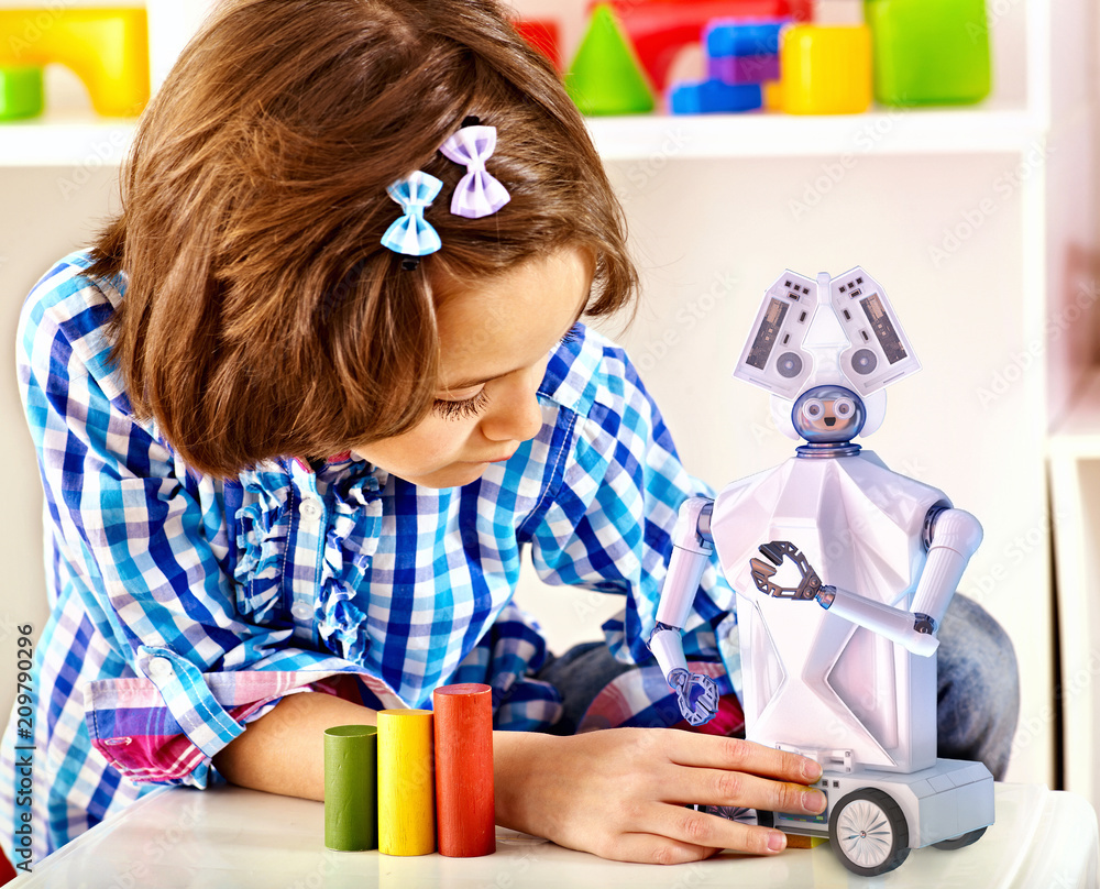 Child build robot toy. Kid engaged in robotics in programming classes. Girl programming own tech smart with artificial intelligence at school. Photo | Adobe Stock