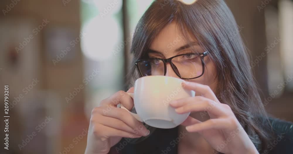 young beautiful girl drinking coffee in a cafe 4k young beautiful girl drinking coffee in a cafe 4k