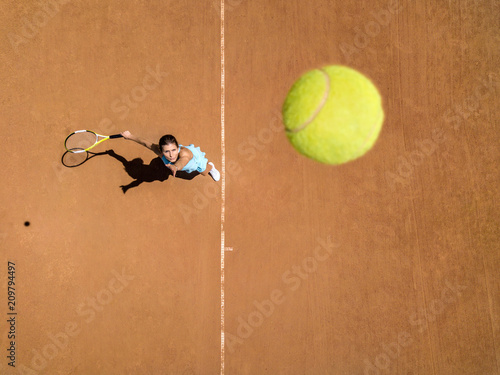 Sportive girl plays tennis © Andriy Bezuglov
