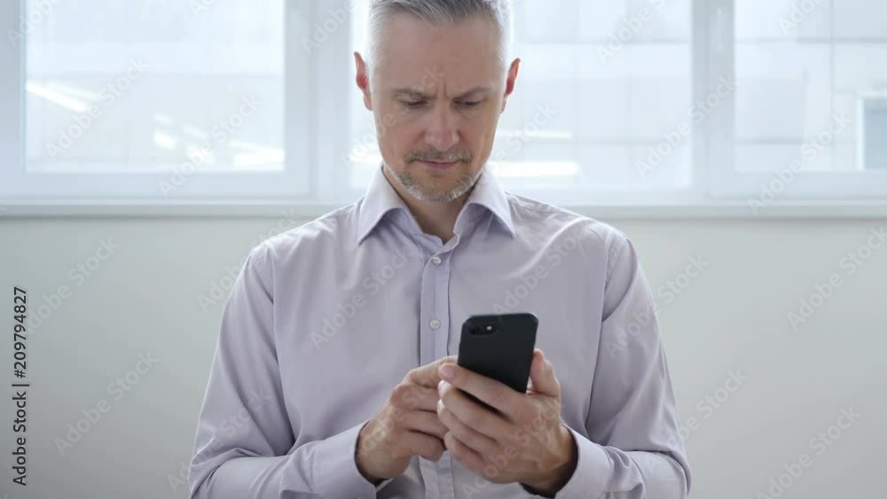 Middle Aged Man Browsing on Smartphone, Using Internet Middle Aged Man Browsing on Smartphone, Using Internet