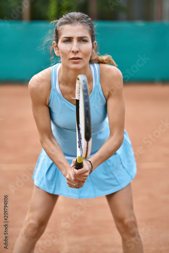 Sportive girl plays tennis © Andriy Bezuglov