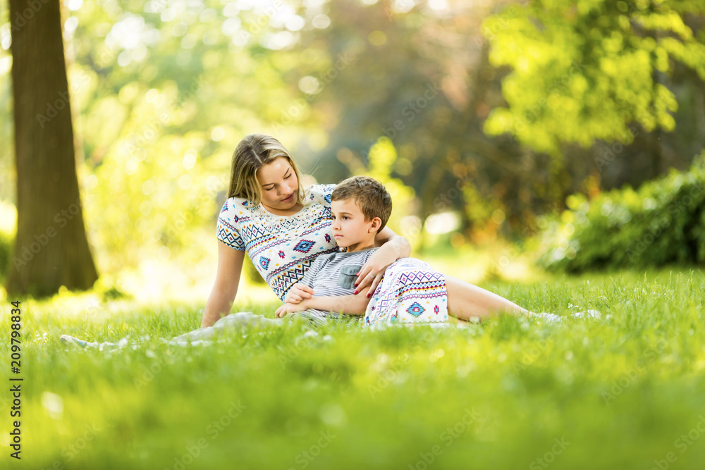 Mother and son on blanket in park Mother and son on blanket in park