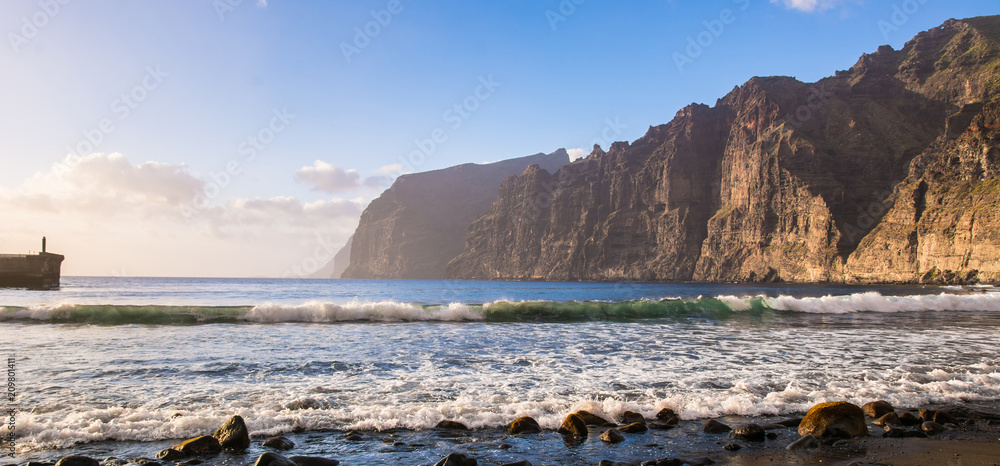 Amazing view of beach in Los Gigantes with high cliffs on the sunset. Location: Los Gigantes, Tenerife, Canary Islands. Artistic picture. Beauty world.