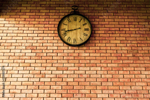 Wall Clock vintage retro styles hanging on the brick wall.