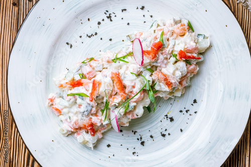 Olivier salad with crab meat photo