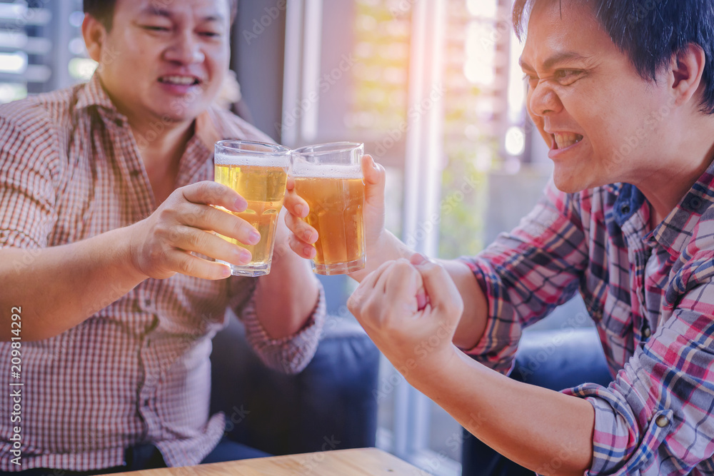Group of friends clinking the glasses of beer in nightclub. Party after working Group of friends clinking the glasses of beer in nightclub. Party after working