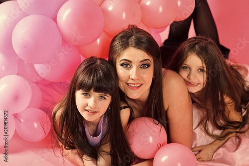 daughter of the mother. Little girls, mom in pink balloons.