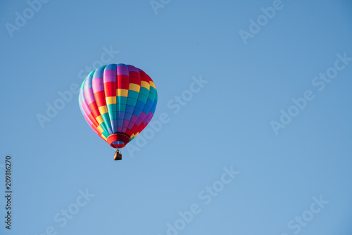 Hot Air Balloon Soaring Up in a Cloudless Blue Sky