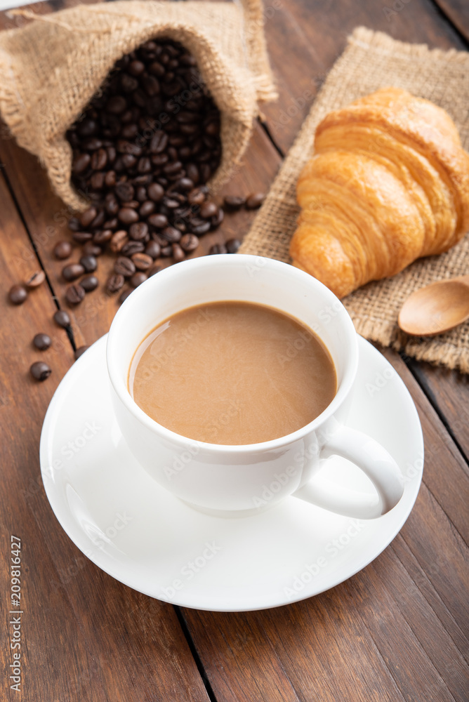 Coffee and croissant on wooden background Coffee and croissant on wooden background