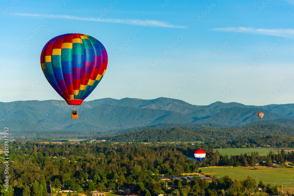 Hot Air Balloon Flying Over Grants Pass, Oregon during the Balloon & Kite Festival Hot Air Balloon Flying Over Grants Pass, Oregon during the Balloon & Kite Festival