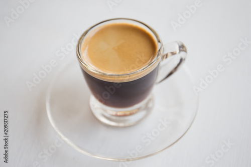 Espresso coffee in glass cup, on a white background.