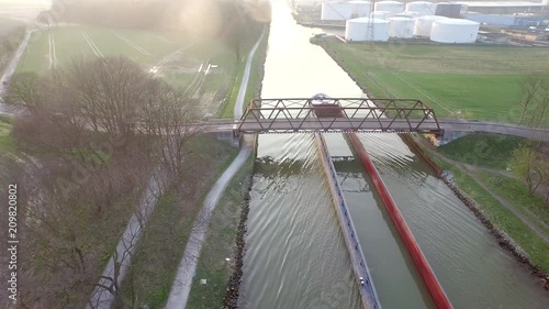 Drone footage of Cargo ship passing by on a german canal. photo