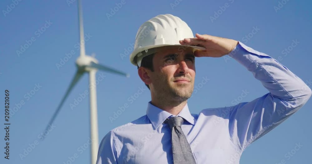 An engineer controls the functioning of wind turbines that run thanks to the force of the wind and generate electricity sustainably to the planet. Concept of: renewable energy, love for nature An engineer controls the functioning of wind turbines that run thanks to the force of the wind and generate electricity sustainably to the planet. Concept of: renewable energy, love for nature