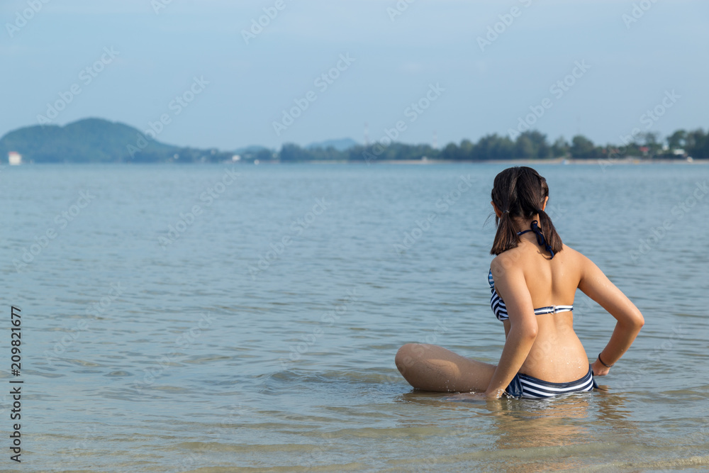 Teenage wearing bikini at the beach. Teenage wearing bikini at the beach.