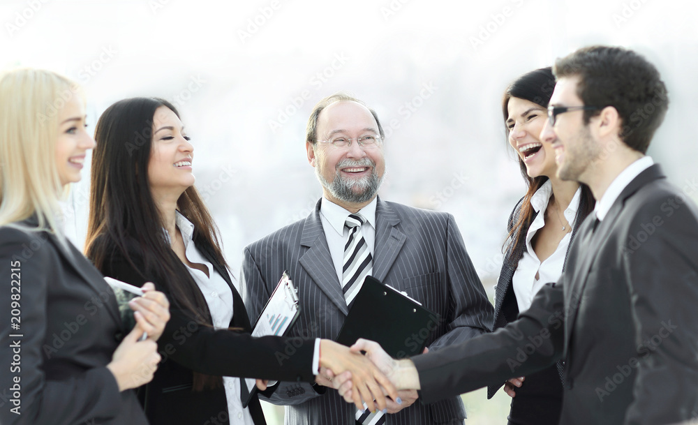 professional business team and shaking hands of young business partners in the office professional business team and shaking hands of young business partners in the office