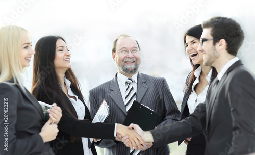 professional business team and shaking hands of young business partners in the office