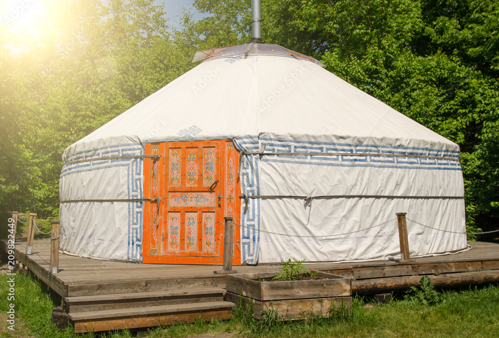 yurta with national Mongolian patterns in summer day with sunny beams