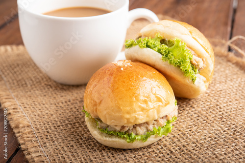 tuna burger and coffee on wood background.