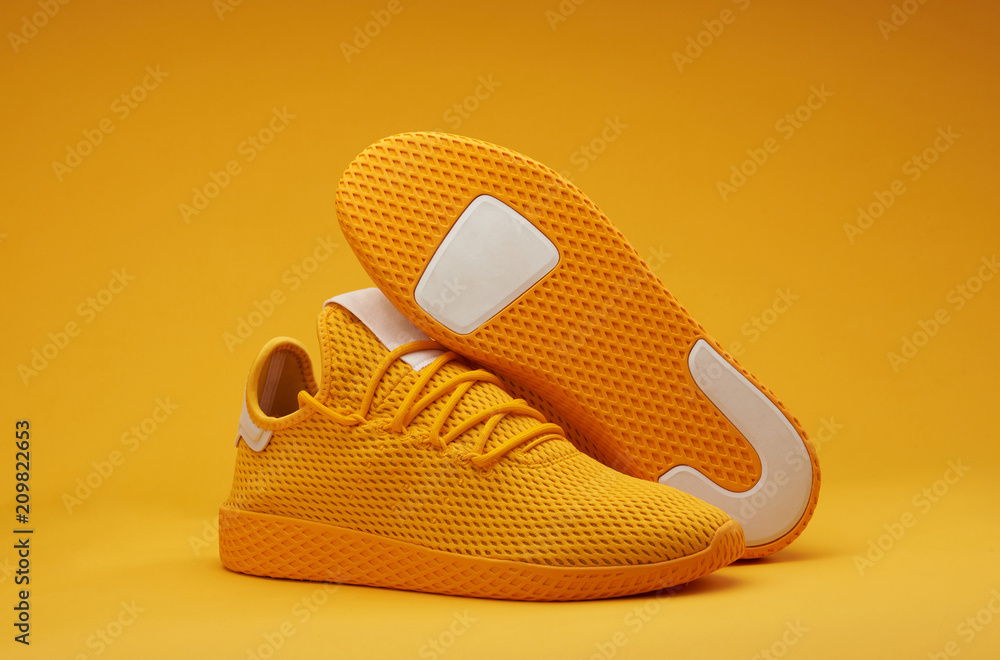 Sport shoes theme in yellow color - obrazy, fototapety, plakaty 